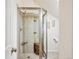 Modern bathroom with a glass-enclosed shower featuring tiled walls, built-in shelving, and a wooden bench at 434 N Washington St, Denver, CO 80203