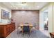 Cozy dining room featuring a brick accent wall, hardwood floors, and a stylish round table at 434 N Washington St, Denver, CO 80203