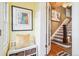 Bright foyer with hardwood floors, stairs, and a cozy bench with storage at 434 N Washington St, Denver, CO 80203