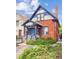 Charming two-story brick home with blue accents, a covered porch, and a well-maintained front yard at 434 N Washington St, Denver, CO 80203