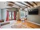 Bright living room with wood floors, exposed beams, a ceiling fan, and glass doors to the backyard at 434 N Washington St, Denver, CO 80203