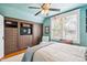 Cozy bedroom features blue textured walls, built-in storage with drawers and shelving, and ample natural light at 434 N Washington St, Denver, CO 80203