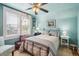 Serene bedroom with light blue walls, a ceiling fan, and large windows with ample natural light at 434 N Washington St, Denver, CO 80203