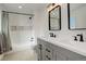Stylish bathroom featuring double vanity, modern fixtures, and tiled shower with built-in niches at 8229 Marshall Ct, Arvada, CO 80003