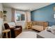 Bright Bedroom with a crib, chair, accent wall, and natural light at 8229 Marshall Ct, Arvada, CO 80003