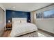 Bedroom featuring a gorgeous accent wall and a large window for natural light at 8229 Marshall Ct, Arvada, CO 80003
