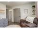 Cozy bedroom showcasing soft colors, plush seating, closet, and calming decor at 8229 Marshall Ct, Arvada, CO 80003
