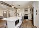 Bright kitchen with a large island, stainless steel appliances, and elegant wood flooring at 8229 Marshall Ct, Arvada, CO 80003