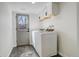 Basement laundry room featuring a modern washer and dryer and overhead storage at 8229 Marshall Ct, Arvada, CO 80003