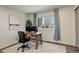 Bright home office space with large window, desk, modern decor, and lots of natural light at 8229 Marshall Ct, Arvada, CO 80003