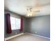 Cozy bedroom featuring a ceiling fan, radiator, and a window with natural light at 7309 W Hampden Ave # 5202, Lakewood, CO 80227