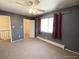 Cozy bedroom featuring a ceiling fan, radiator, and a window with natural light at 7309 W Hampden Ave # 5202, Lakewood, CO 80227