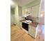 Cozy kitchen with laminate counters, wood cabinets, and laminate floors at 7309 W Hampden Ave # 5202, Lakewood, CO 80227