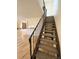 A clean staircase leads to the upper levels of the home at 7309 W Hampden Ave # 5202, Lakewood, CO 80227