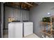 Basement laundry area with washer, dryer, and shelving for storage and organization at 871 S Joplin Cir, Aurora, CO 80017
