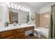 Bathroom with wood vanity, tile walls, shower curtain, and white fixtures at 871 S Joplin Cir, Aurora, CO 80017