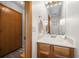 Bathroom features oak vanity, white sink and countertop, and wood-look flooring at 871 S Joplin Cir, Aurora, CO 80017