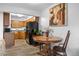 Dining area with view of kitchen featuring wood cabinets and black appliances at 871 S Joplin Cir, Aurora, CO 80017