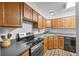 Cozy kitchen features stainless steel appliances, wood cabinets, and modern countertops at 871 S Joplin Cir, Aurora, CO 80017