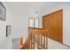 Second floor landing with carpet, wood railing, and closet at 871 S Joplin Cir, Aurora, CO 80017