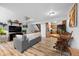 Open-concept living area with wood floors that flows into the kitchen and staircase at 871 S Joplin Cir, Aurora, CO 80017