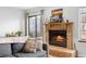 Living room with a brick fireplace and sliding door to the outdoor area at 871 S Joplin Cir, Aurora, CO 80017