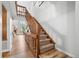 Carpeted staircase with wood banister leading to the second floor at 871 S Joplin Cir, Aurora, CO 80017