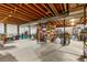 Unfinished basement space with exposed wood beams and ample storage shelving for versatile use at 4788 Briar Ridge Trl, Boulder, CO 80301