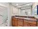 Bathroom featuring double sinks, granite counters, a large mirror, and a glass-enclosed shower at 4788 Briar Ridge Trl, Boulder, CO 80301