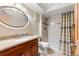 Cozy bathroom featuring a wood vanity with a stone countertop and a shower with patterned curtains at 4788 Briar Ridge Trl, Boulder, CO 80301