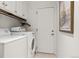 Functional laundry room equipped with a washer, dryer, and built-in storage cabinets at 4788 Briar Ridge Trl, Boulder, CO 80301
