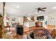 Open-concept living space with hardwood floors, a kitchen island, stone fireplace, and comfortable seating arrangements at 4788 Briar Ridge Trl, Boulder, CO 80301
