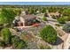 A landscaped backyard features a garden, patio, and cozy deck at 21395 E Greenwood Pl, Aurora, CO 80013