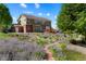 The two-story home features a backyard garden and a cozy deck at 21395 E Greenwood Pl, Aurora, CO 80013