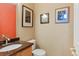 Half-bathroom featuring a stylish sink and vanity area with decorative wall art at 21395 E Greenwood Pl, Aurora, CO 80013