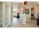 Inviting hallway with tile flooring, decorative columns, and views into the living room and dining room at 21395 E Greenwood Pl, Aurora, CO 80013