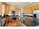 Well-lit kitchen featuring stainless steel appliances and a dark marbled island at 21395 E Greenwood Pl, Aurora, CO 80013