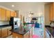 Open kitchen featuring stainless steel refrigerator and island with easy access to living space at 21395 E Greenwood Pl, Aurora, CO 80013