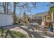 Inviting backyard features a patio with outdoor dining area and mature trees at 2252 S Lafayette St, Denver, CO 80210