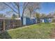 Spacious backyard features a well-maintained lawn and a charming blue outbuilding at 2252 S Lafayette St, Denver, CO 80210
