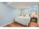 Bedroom with a queen-sized bed with striped bedding and a side table with a lamp at 2252 S Lafayette St, Denver, CO 80210