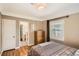 Bedroom featuring wood floors, neutral walls, and a door to the bathroom at 2252 S Lafayette St, Denver, CO 80210