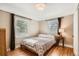 Cozy bedroom featuring wood floors, two windows, and neutral-toned walls at 2252 S Lafayette St, Denver, CO 80210