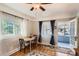 Charming dining area with hardwood floors, window views, and easy access to the sunroom at 2252 S Lafayette St, Denver, CO 80210