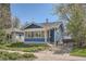 Charming blue home with a sunroom, front yard, and brick driveway, perfect for cozy living at 2252 S Lafayette St, Denver, CO 80210