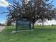 Sign for Harvard Gulch Golf Course with lush trees around it on a sunny day at 2252 S Lafayette St, Denver, CO 80210