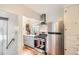 Bright kitchen featuring gray cabinets, stainless steel appliances, and view to backyard at 2252 S Lafayette St, Denver, CO 80210