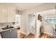 Bright kitchen featuring gray cabinets, white upper cabinets, and access to bedroom at 2252 S Lafayette St, Denver, CO 80210