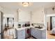 Bright kitchen featuring gray lower cabinets, white upper cabinets, and stainless steel appliances at 2252 S Lafayette St, Denver, CO 80210