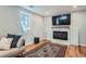 Cozy living room with electric fireplace, mounted TV, stylish rug, and comfortable seating at 2252 S Lafayette St, Denver, CO 80210